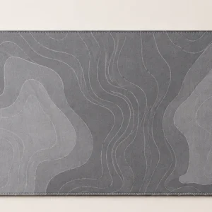 Grey desk mat with abstract contour flow and contrast stitching