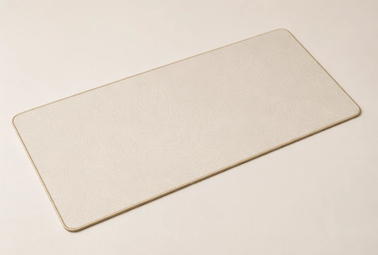 Three-quarter view of the Contour Ivory Desk Pad showing its surface and edge profile