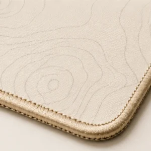 Close-up of the weave and stitched edge of the Contour Ivory Desk Pad