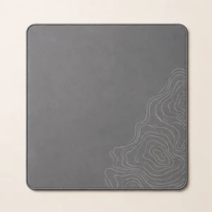 Square slate-grey mouse mat with white contour lines in one corner