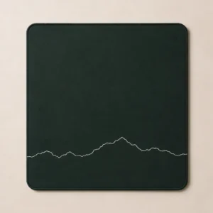 Full-desk mat with a white panoramic mountain ridge line on deep green